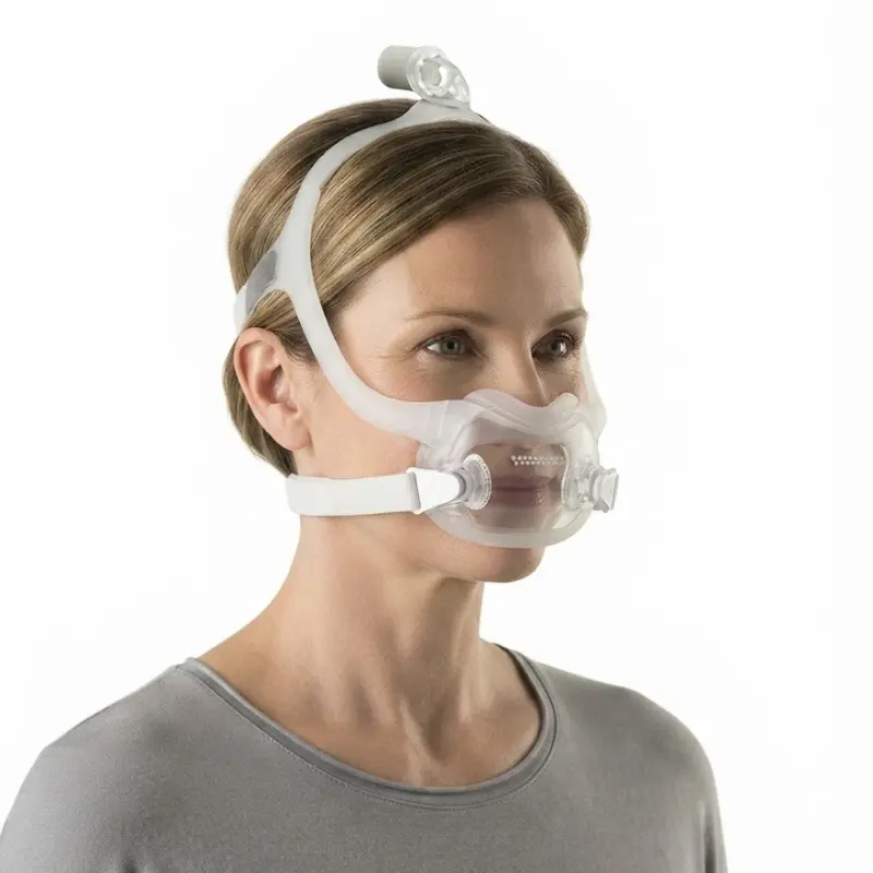 Mujer perfilada luciendo la máscara facial Philips DreamWear Full Face en talla L para terapia respiratoria.