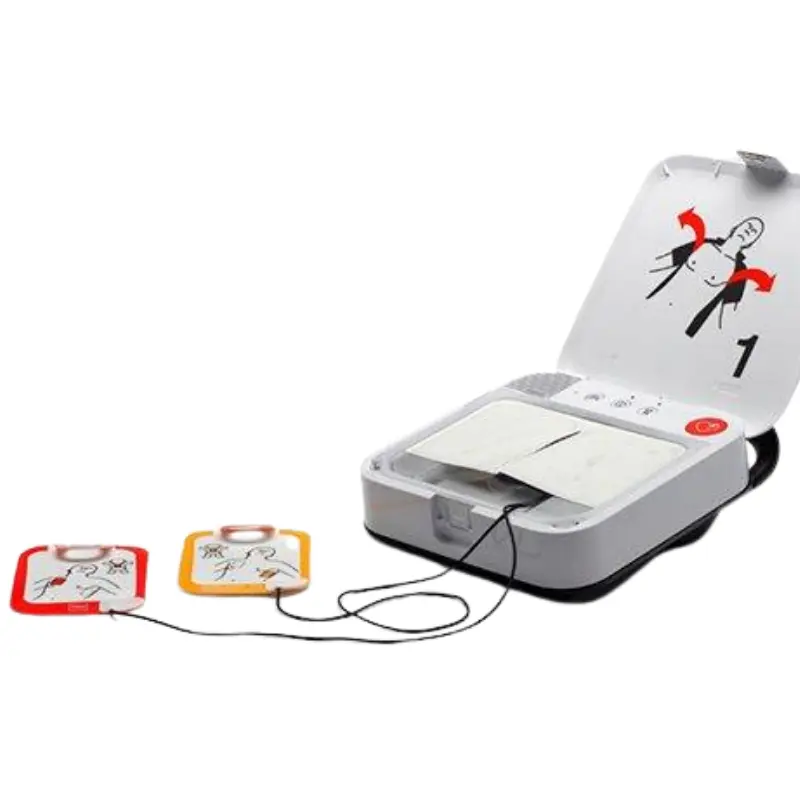 Desfibrilador Physio-Control Lifepak CR2 abierto con los electrodos conectados y extendidos sobre una superficie blanca.